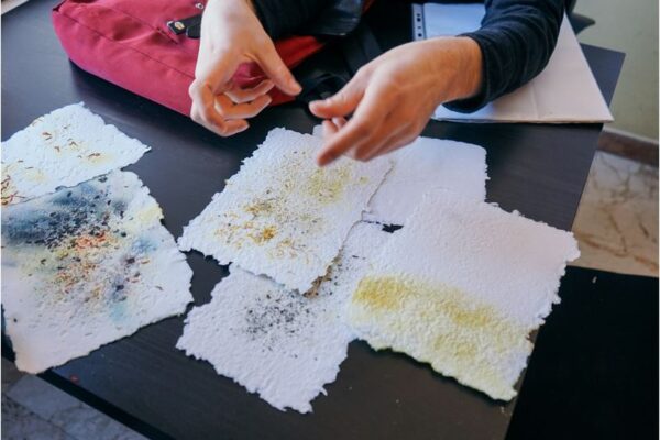 Sheets of paper made by hand during the workshop, still drying on the table