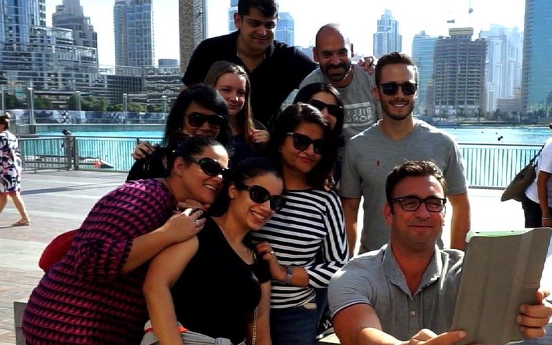 A team reading a clue on a tablet by the Dubai Fountain