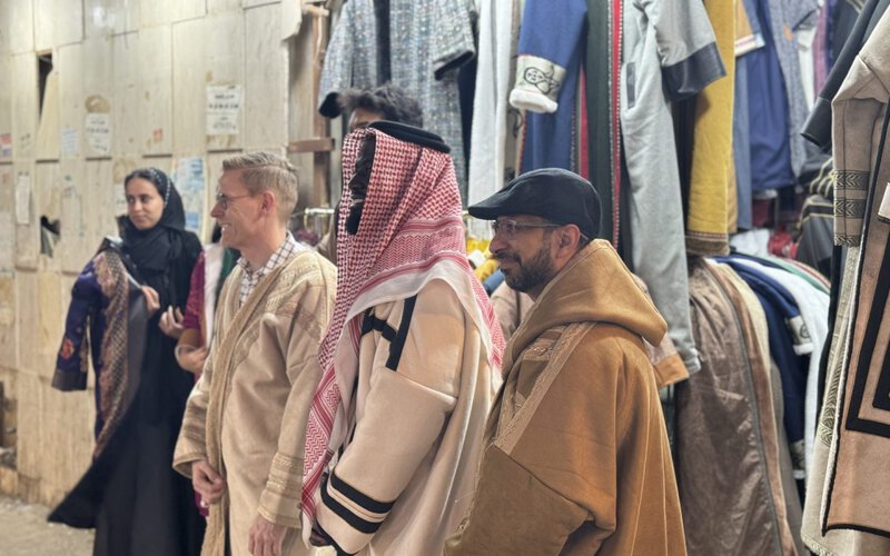 A team walking through the souk with a local guide during an urban game in Riyadh