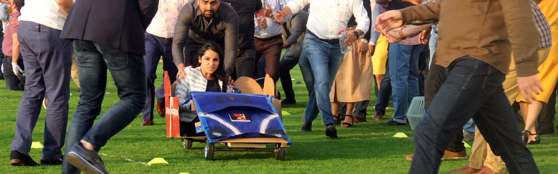 A cart built by the team running the course while the whole group runs alongside